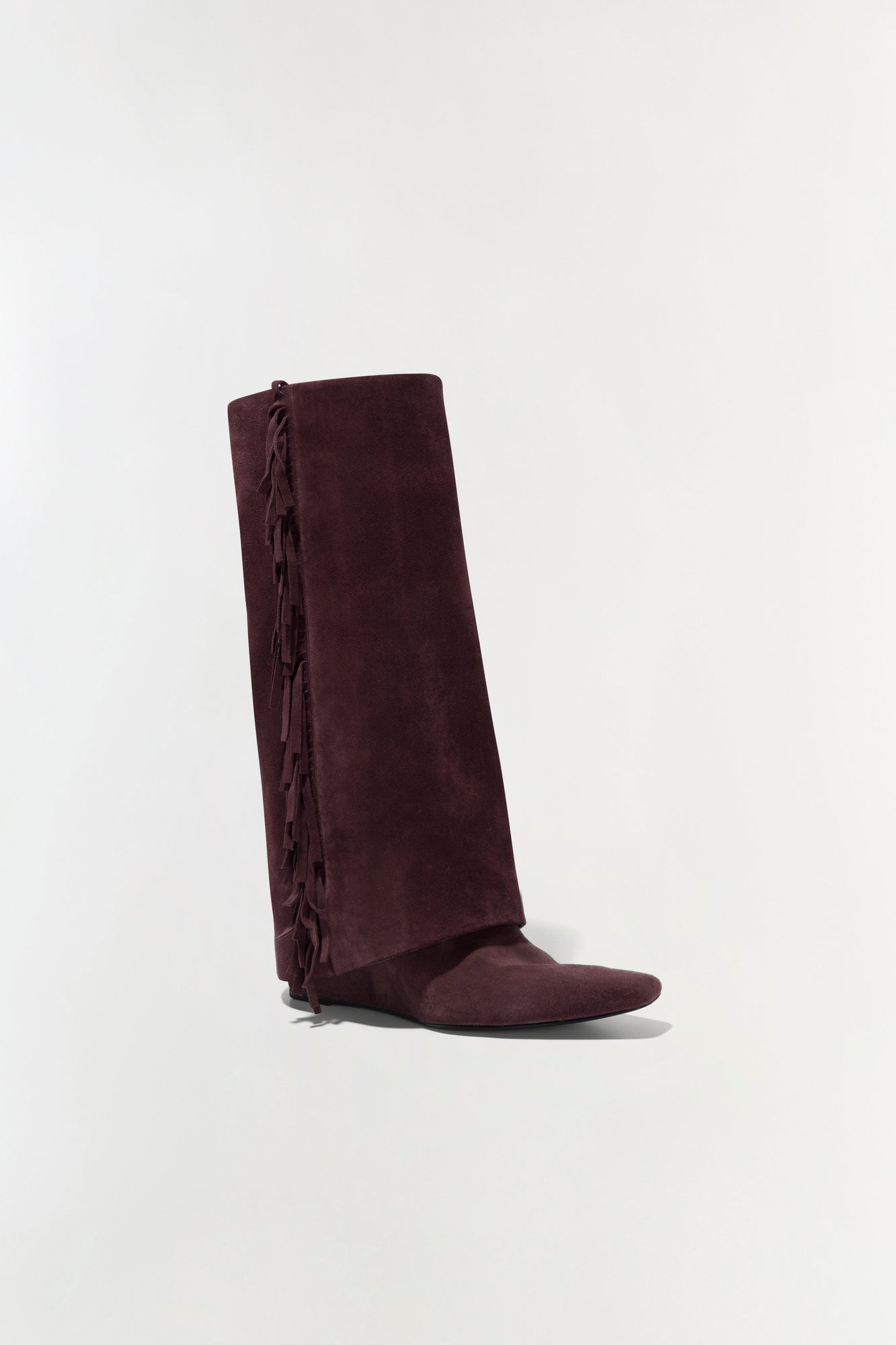 Burgundy suede knee-high boot with fringe trim down the back shaft.