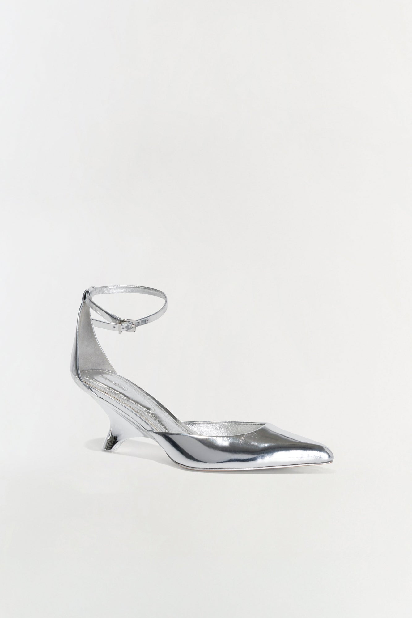 Silver metallic leather wedge pump with pointed toe and ankle strap buckle closure.