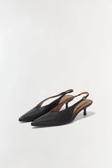 Black leather slingback kitten heels with pointed toe and tan leather interior lining.