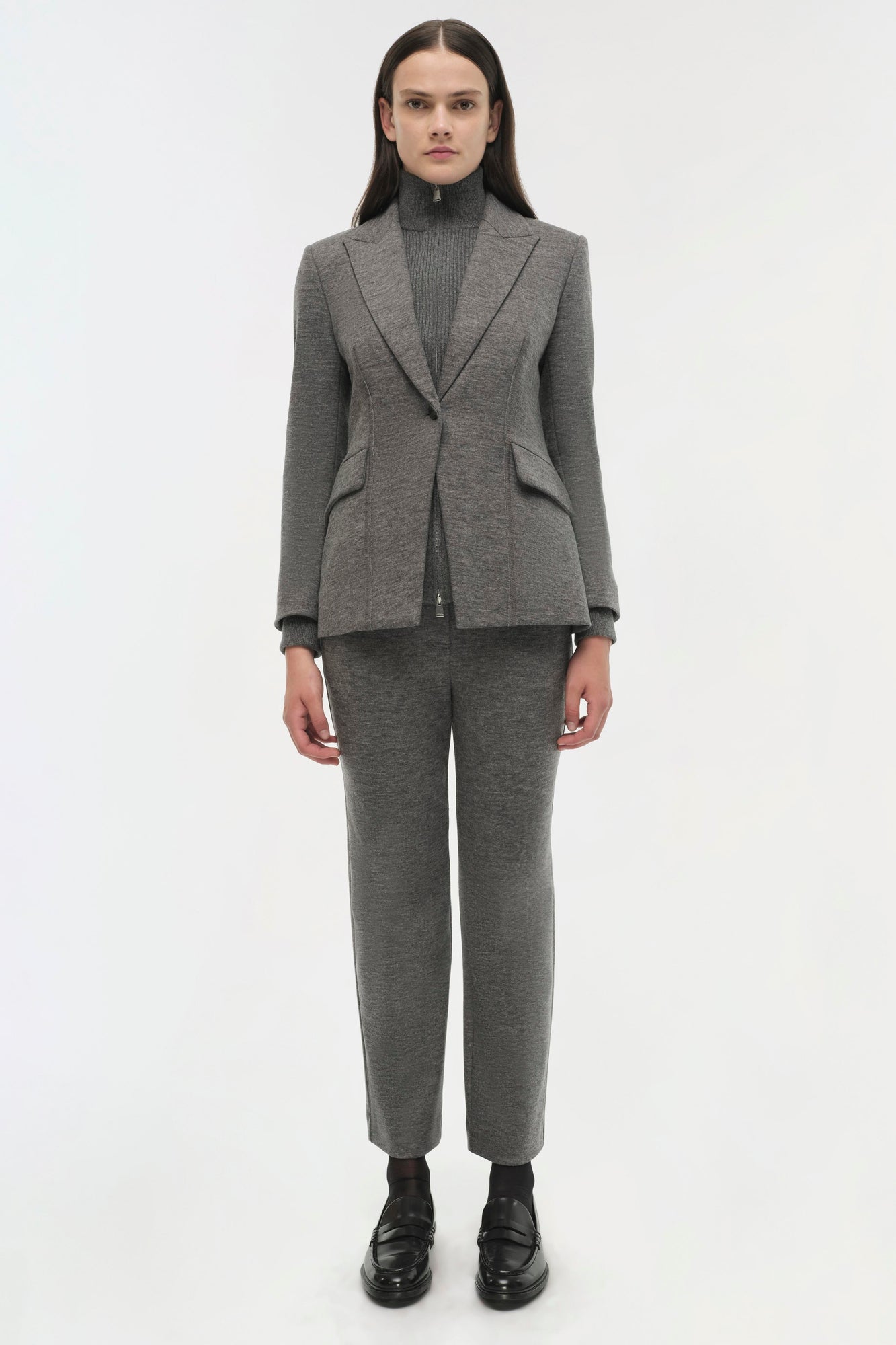 Gray wool blazer with notch lapels worn with matching ribbed turtleneck and cropped trousers.