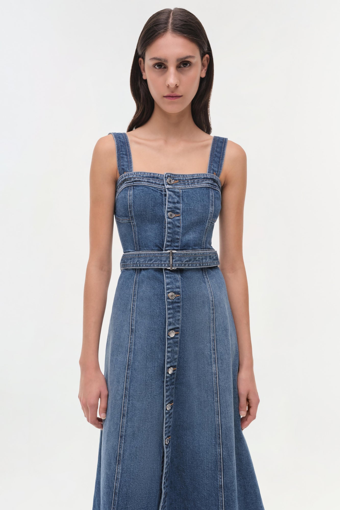 Blue denim sleeveless dress with square neckline, button front, and belted waist.