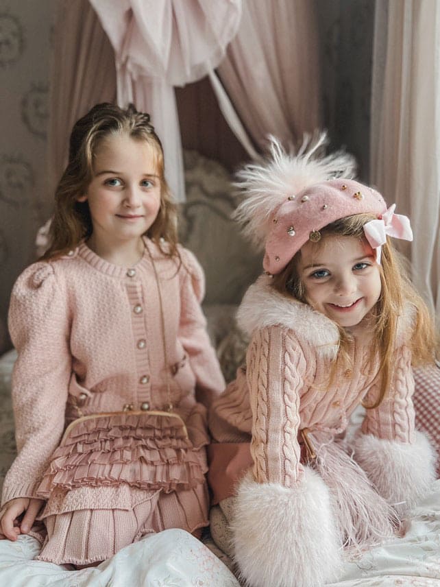 Dusty pink organza ruffle handbag paired with matching outfits, featuring the gold chain strap and matching clasp detail