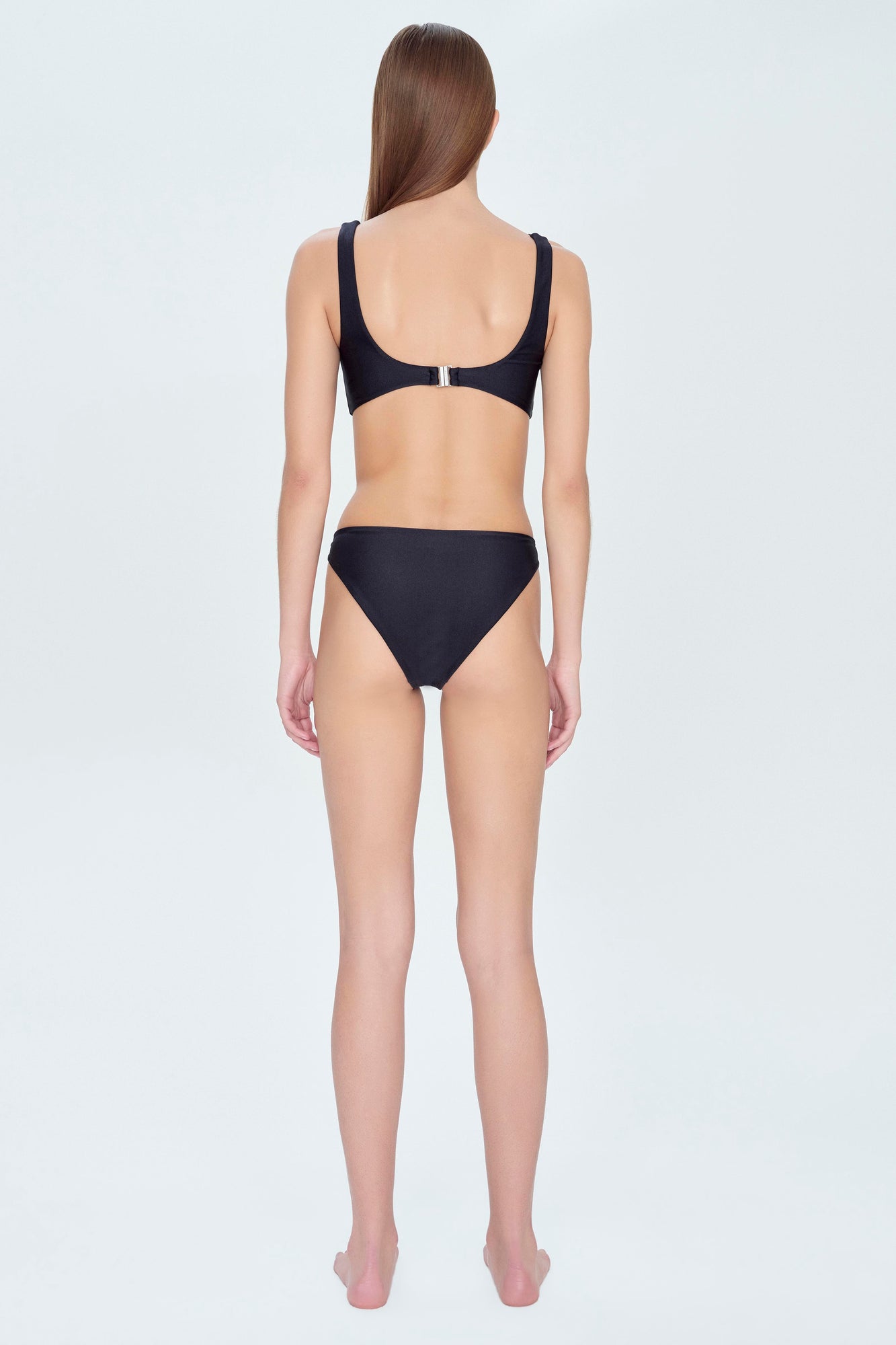 Black two-piece swimsuit with scoop neckline, wide shoulder straps, and back clasp closure, shown from behind.