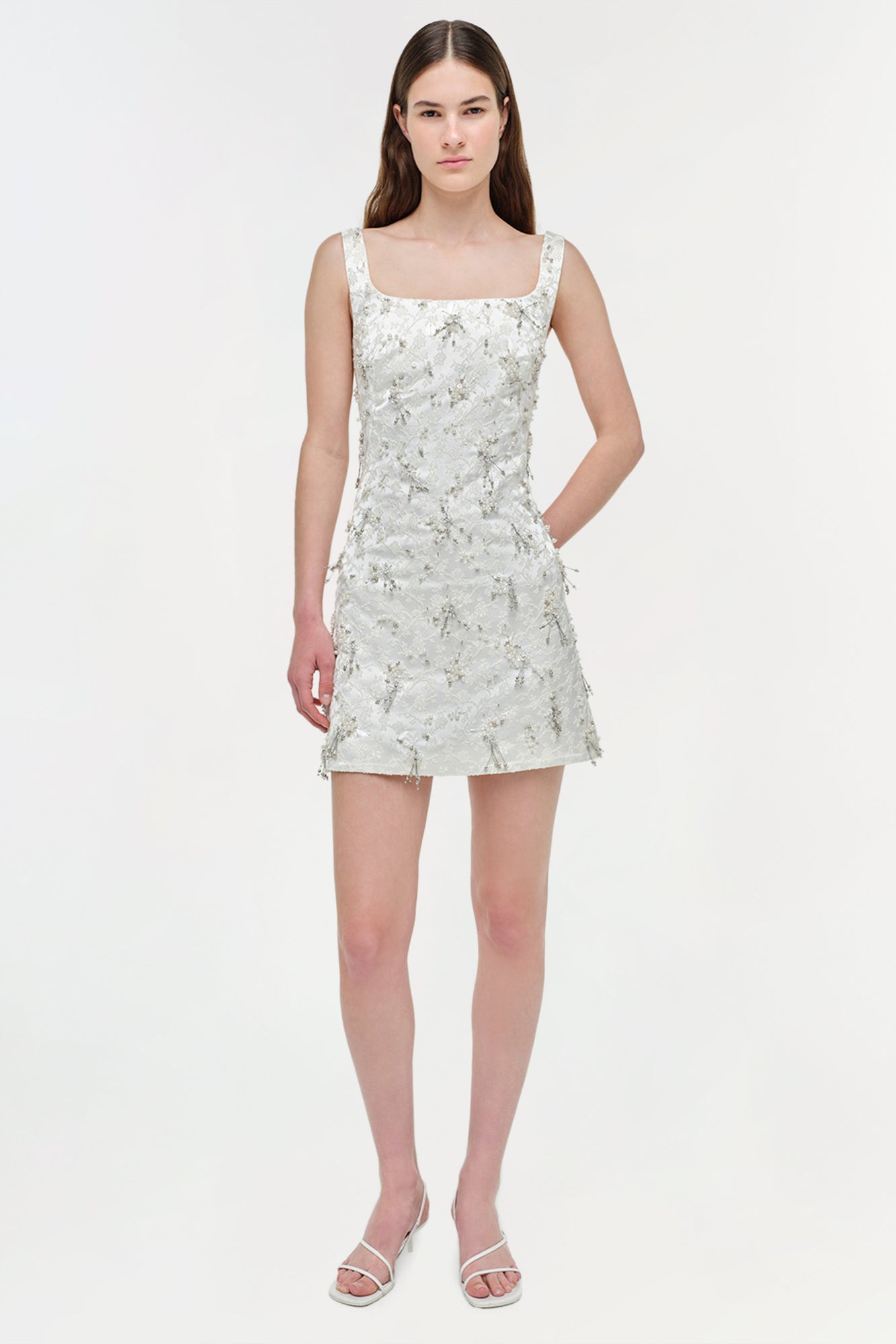 White embellished jacquard mini dress with square neckline, sleeveless design, and side pocket.