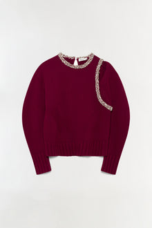 Burgundy ribbed pullover with crystal beading around the neckline and down the front.