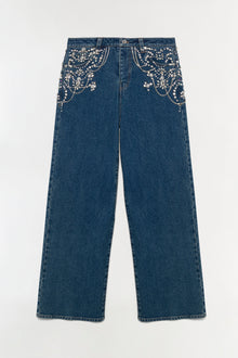 Dark blue crop jeans with pearl and rhinestone embellishments on front pockets and waistband.