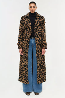 Leopard print wool overcoat with notched collar, worn over black turtleneck and blue jeans.