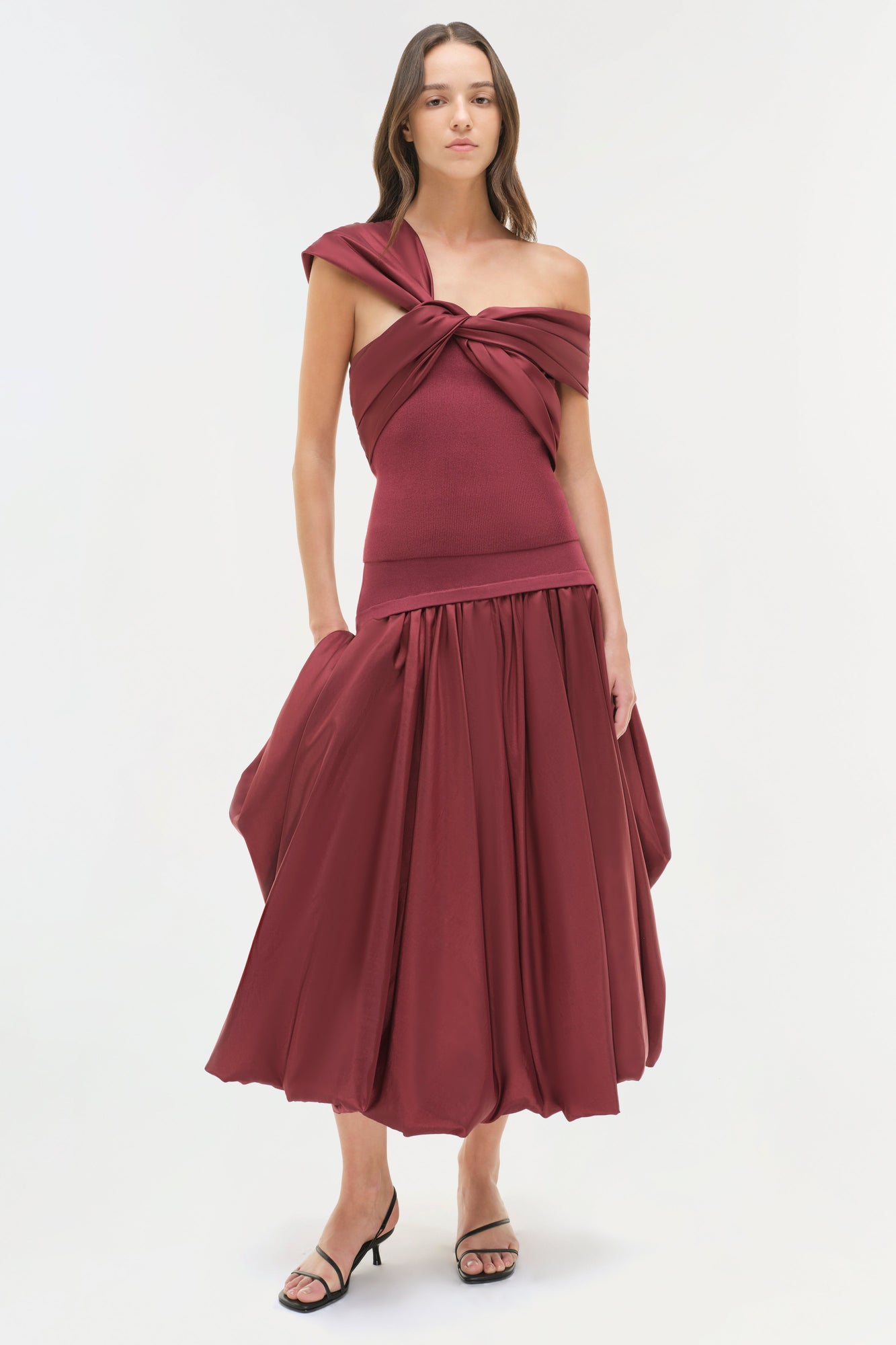 Burgundy off-shoulder top with twisted neckline and matching full skirt.