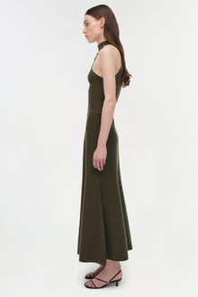 Olive green sleeveless halter dress with a fitted bodice and flowing midi skirt, shown on a model in profile view.