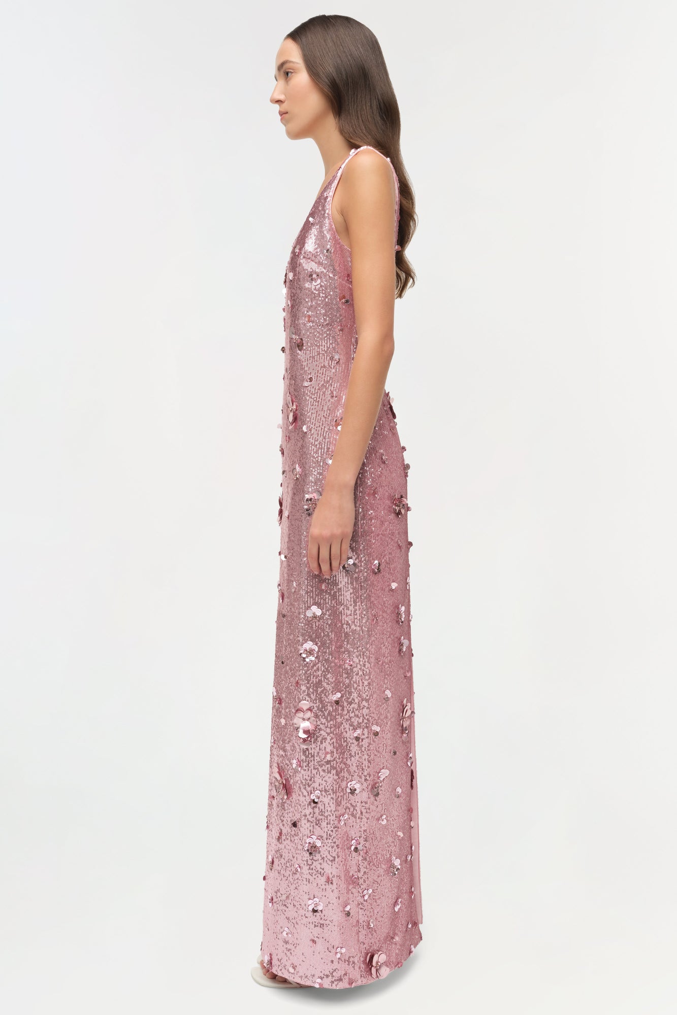 Mauve sequin sleeveless gown with allover embellishments, shown on model in profile view.
