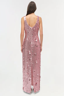 Sleeveless mauve sequin gown with low open back and high front slit, modeled from behind.