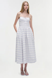 White and lavender gingham cotton midi dress with thin straps, fitted bodice, and full skirt on model.