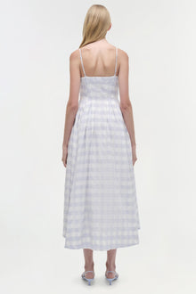 Woman wearing a light lavender gingham midi dress with thin straps and fitted bodice, shown from the back.