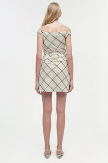Beige mini dress with diagonal grid pattern and off-shoulder neckline, shown from back on model.