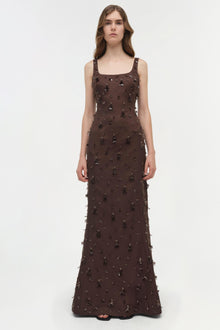 Brown sleeveless gown with scattered beaded and tassel embellishments throughout, square neckline and floor-length silhouette