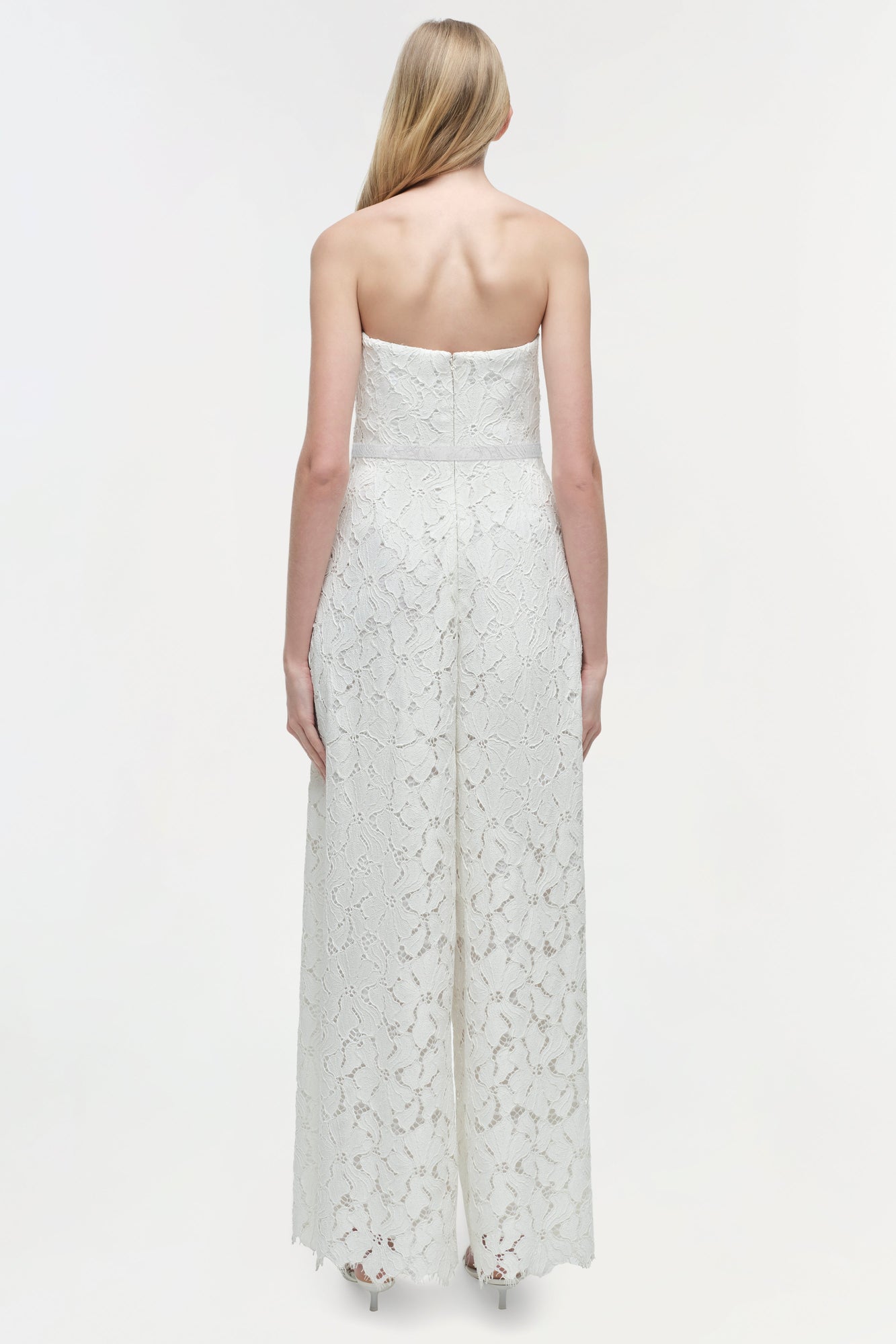 White lace strapless jumpsuit with straight neckline and wide-leg pants, shown from back view.