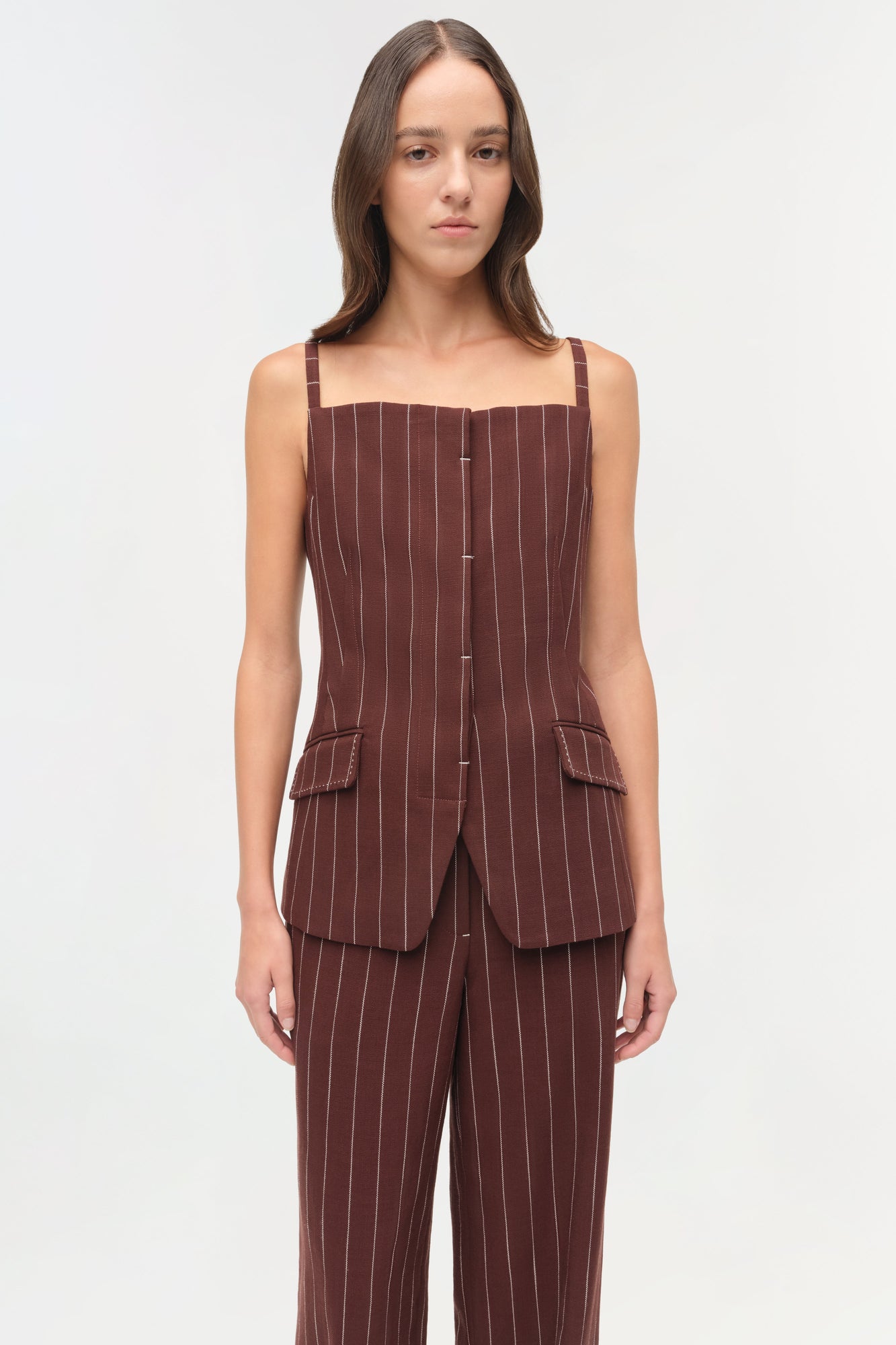 Burgundy pinstriped sleeveless top with square neckline, button front, and patch pockets.
