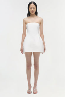 White strapless mini dress with fitted bodice and flared skirt hem, shown on model with strappy sandals.