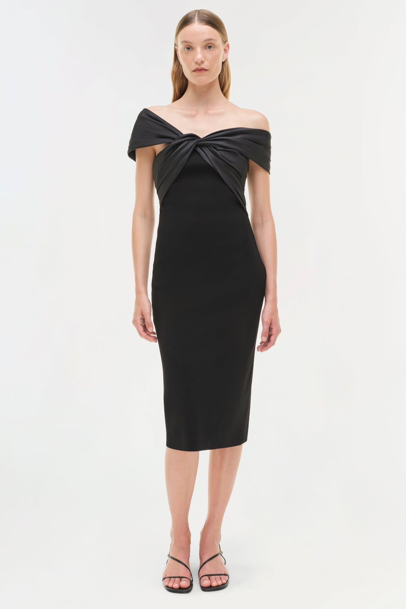 Black off-shoulder midi dress with twisted neckline detail and fitted silhouette.