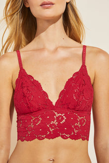 Model wears Naya Longline Bralette in haute red.