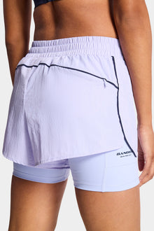 Bandier | Contrast Run Short | Baby Lavender/Navy Blazer