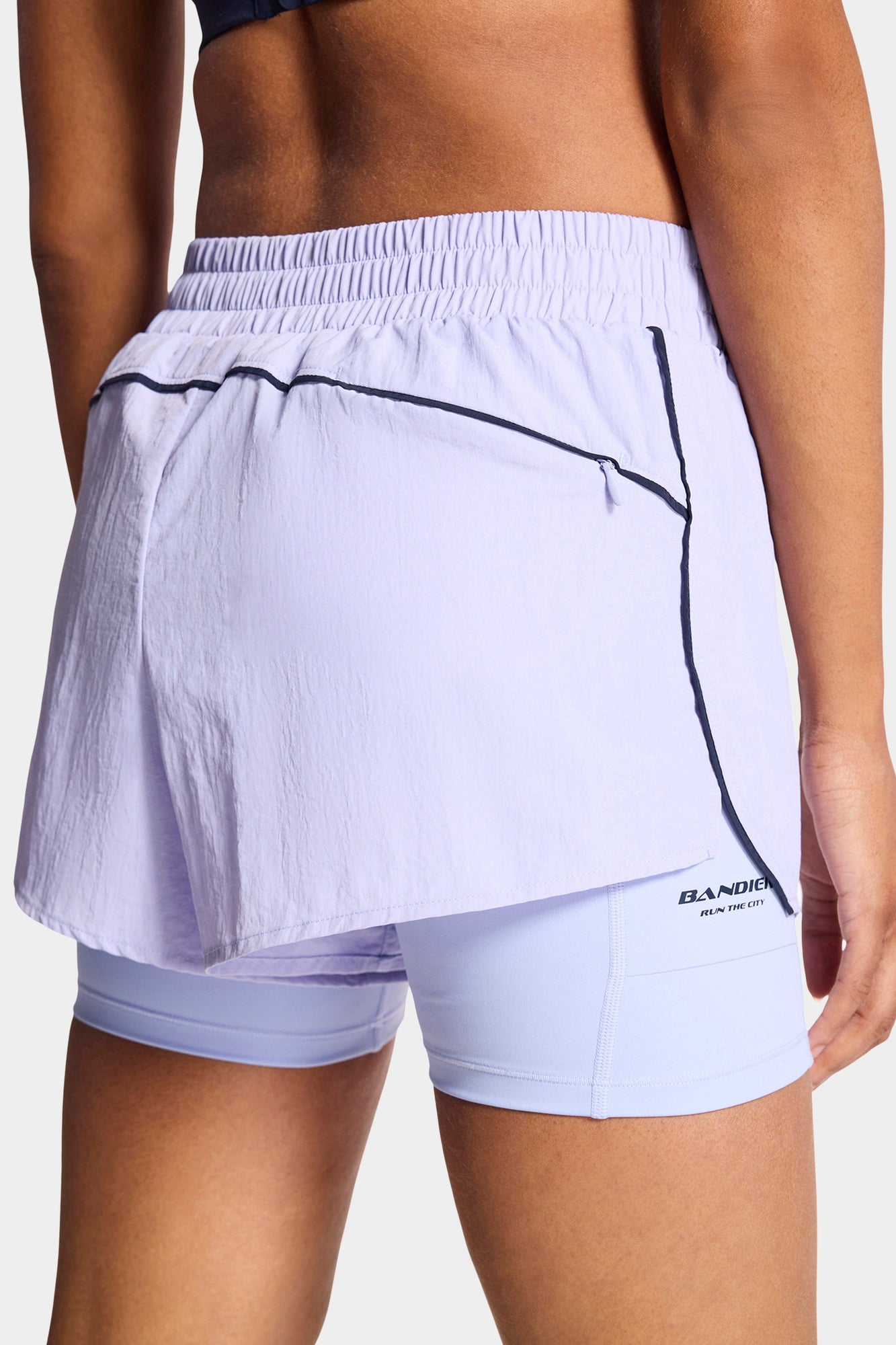 Bandier | Contrast Run Short | Baby Lavender/Navy Blazer
