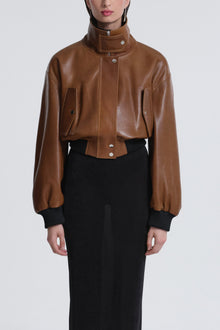Model is wearing Nour Hammour Briar Cropped Bomber Jacket Praline Patina - Front