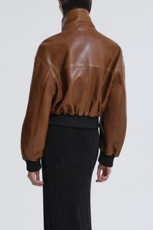 Model is wearing Nour Hammour Briar Cropped Bomber Jacket Praline Patina - Back