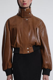 Model is wearing Nour Hammour Briar Cropped Bomber Jacket Praline Patina - Front