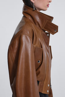 Model is wearing Nour Hammour Briar Cropped Bomber Jacket Praline Patina - Close Up