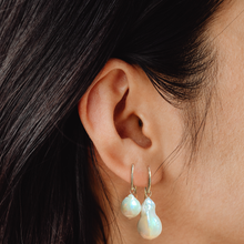 14k gold Mini Baroque Pearl Drop Earrings styled on a ear next to the large baroque pearl drop earring