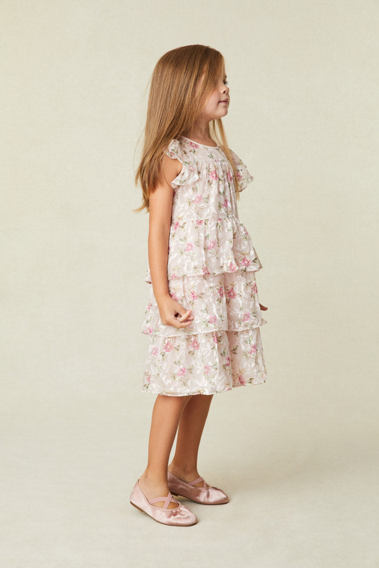 Beautiful Floral Print Dress with Flutter sleeves frame the roomy bodice. An encased elastic waist lets out into a three-tiered ruffle skirt. 