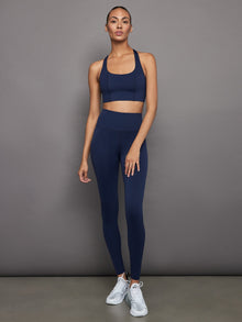 Full outfit view of navy sports bra with matching leggings.