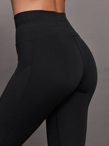 Back close up of Melt High Rise Sport Pocket Legging Black sculpting waistband fit.