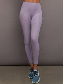 Model wears lavender grey, high-rise ribbed leggings with a fitted, full-length silhouette.