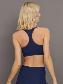 Back view of ribbed Melt racerback bra in true navy showing straps.