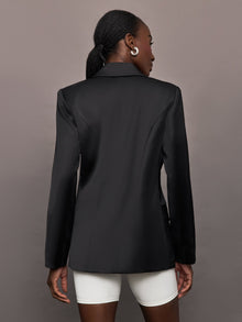 Model wears a black satin single breasted blazer. 