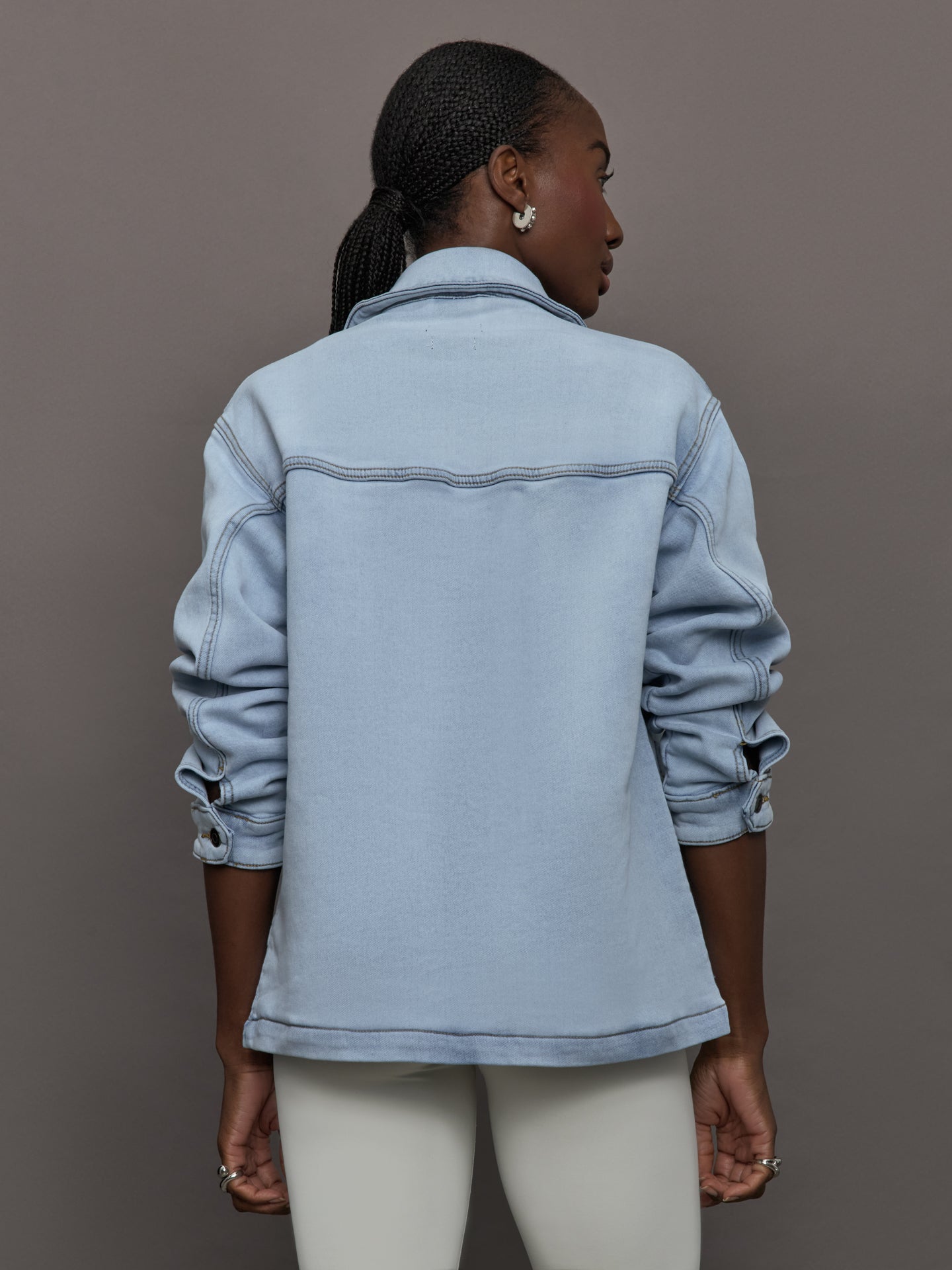 Model wears a light washed denim shirt jacket.