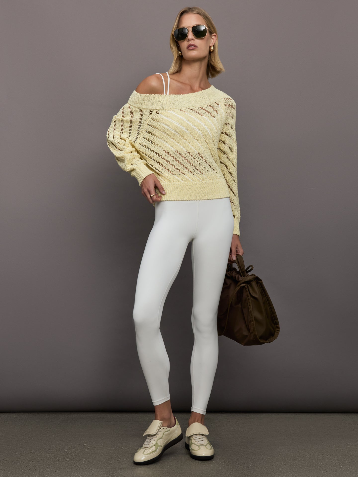 Model wears a yellow off shoulder mesh cardigan with diagonal pattern. 