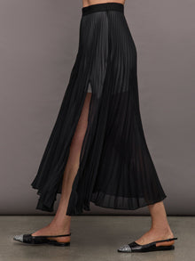 Angled side view of model in Mesh Pleated Sheer Skirt Black showing pleated mesh movement.
