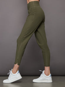 Model wearing Melt cropped jogger with tulip hem in olive, side view.