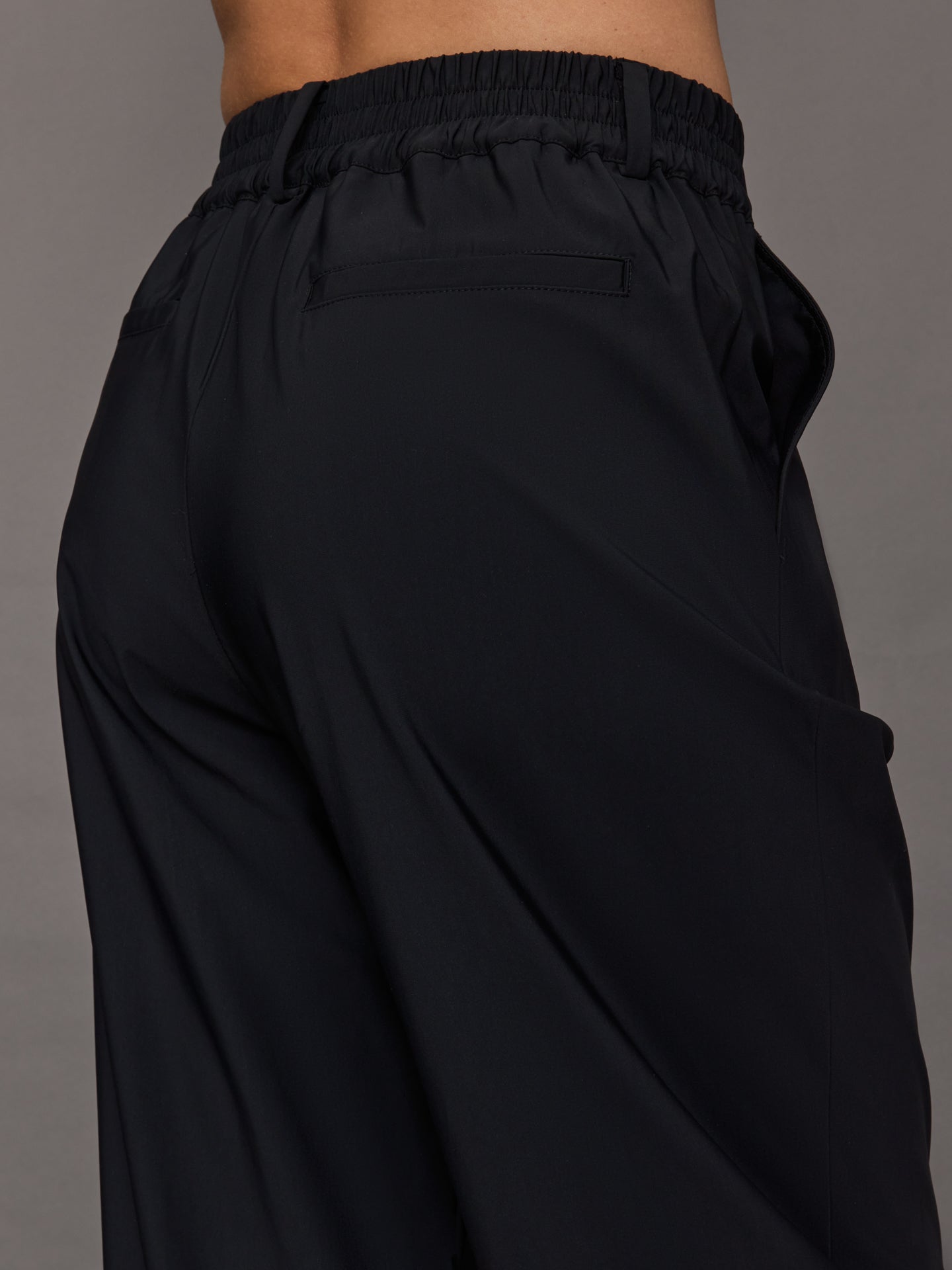 Model wears a pair of black wide leg versatile trousers. 