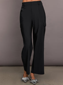 A pair of black stretch woven wide-leg cargo pants with oversized pockets, displayed on a model without showing the upper part of the body.