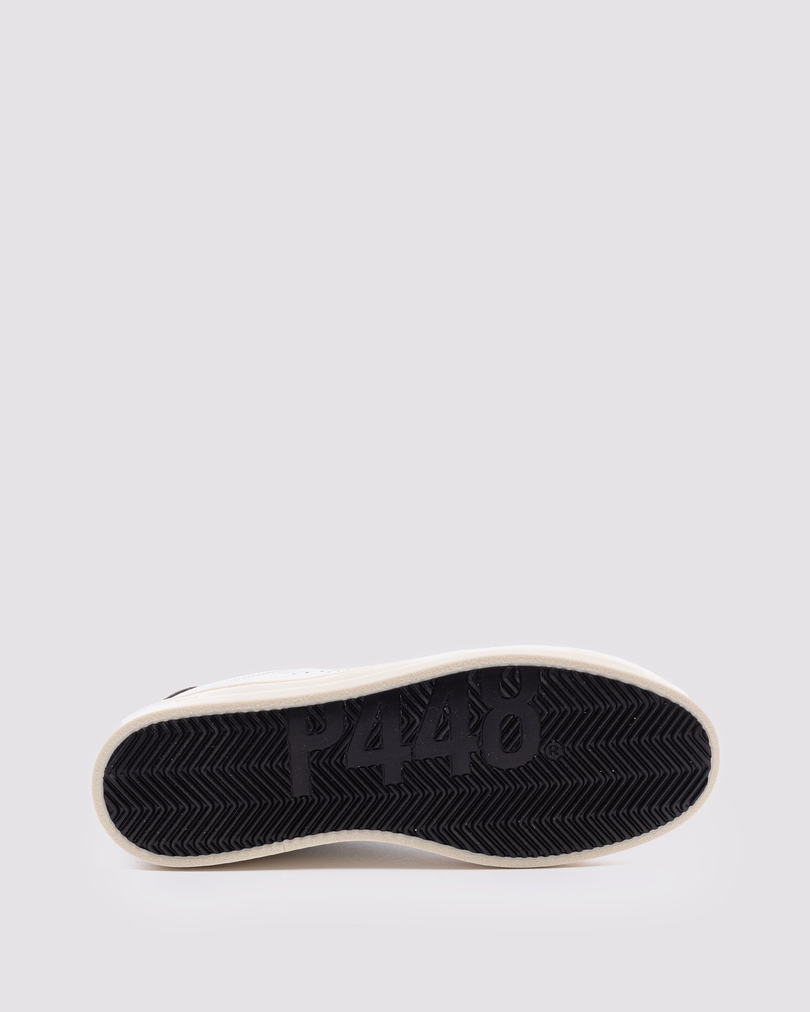 Bottom angle of white and  green sneakers
