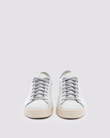 Front angle of white and  green sneakers