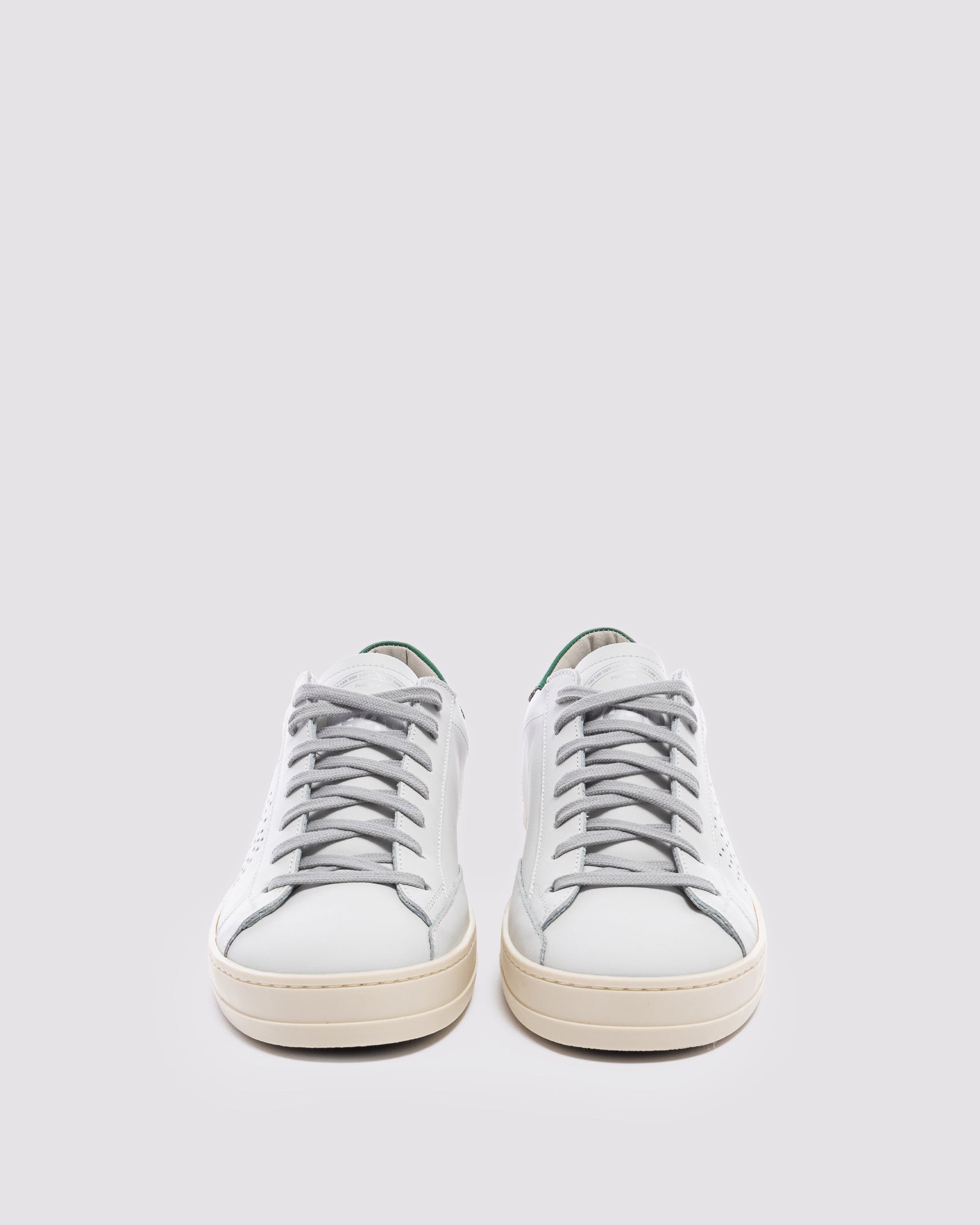 Front angle of white and  green sneakers