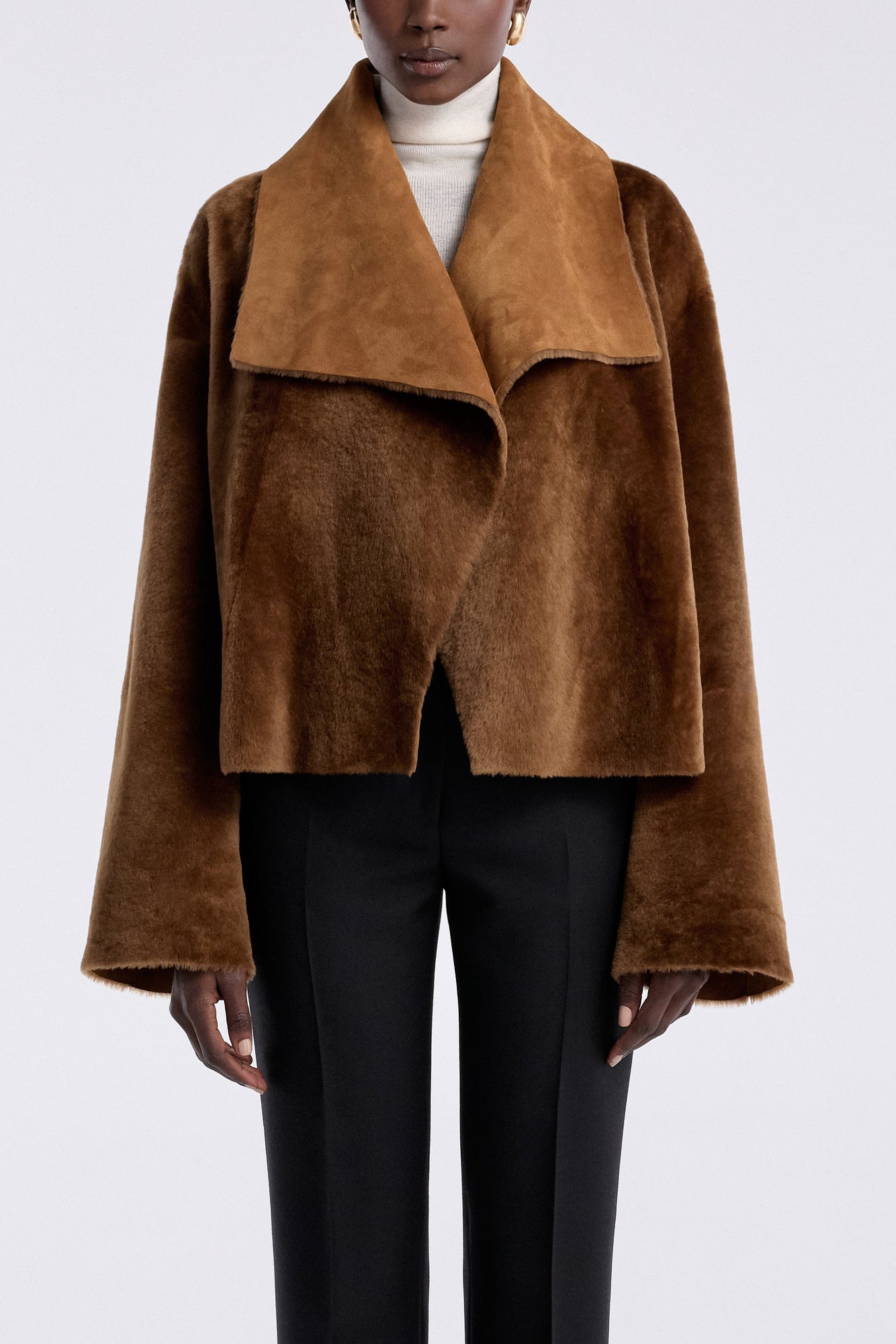 Model is wearing the Nour Hammour Cascade Draped Shearling Jacket Marigold - Front Closed