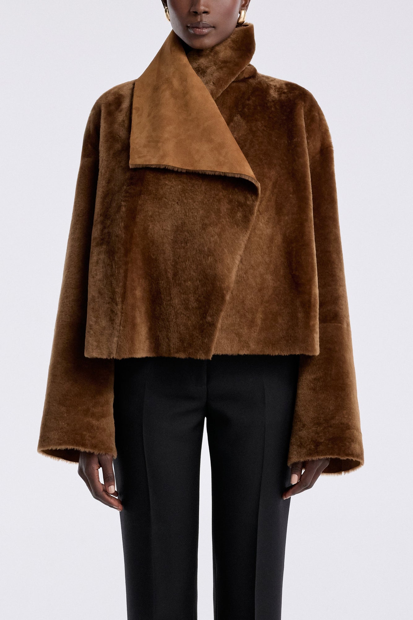 Model is wearing the Nour Hammour Cascade Draped Shearling Jacket Marigold - Front Reverse