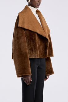 Model is wearing the Nour Hammour Cascade Draped Shearling Jacket Marigold - Three Quarters