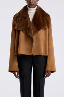 Model is wearing the Nour Hammour Cascade Draped Shearling Jacket Marigold - Front
